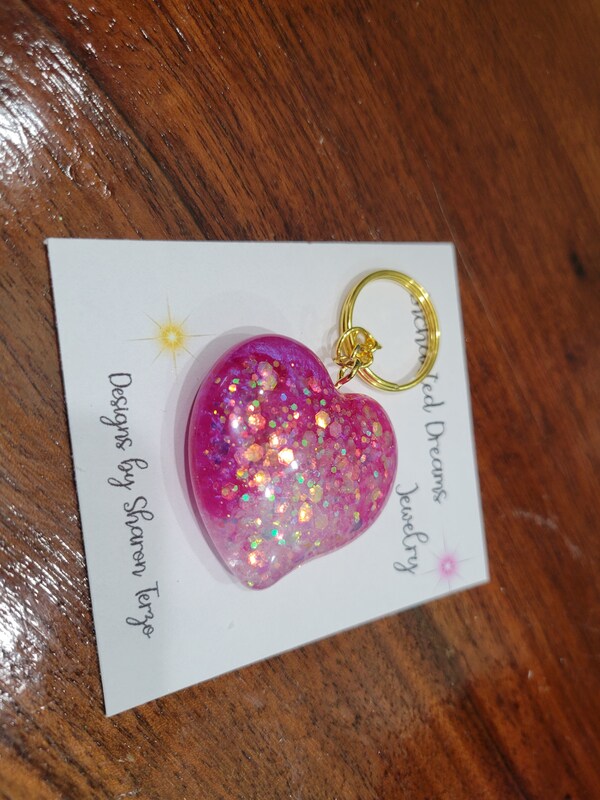Large handpoured resin and glitter heart shaped keychain aprx 1.75x1.75 inches. Great gift idea valentines day